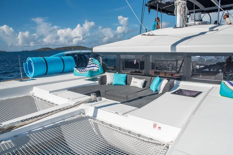 Grace Yacht Photos Pics Luxurious Lagoon 52 F catamaran deck with seating, ocean view, and blue sky.