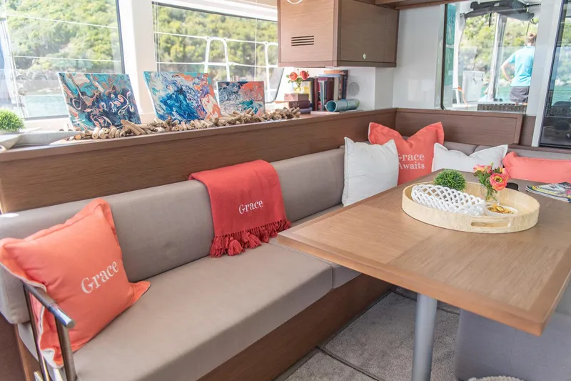 Grace Yacht Photos Pics Interior of 2020 Lagoon 52 F yacht with cozy seating and decorative pillows.