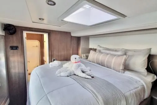 Sea Breeze Yacht Photos Pics Luxurious bedroom in 2023 Bali 5.4 yacht with elegant bedding and towel art.