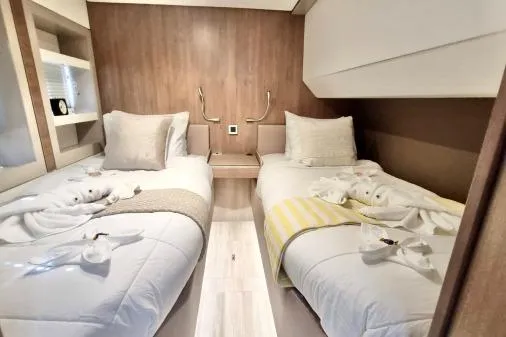 Sea Breeze Yacht Photos Pics Modern twin cabin in 2023 Bali 5.4 yacht, featuring cozy beds and elegant decor.