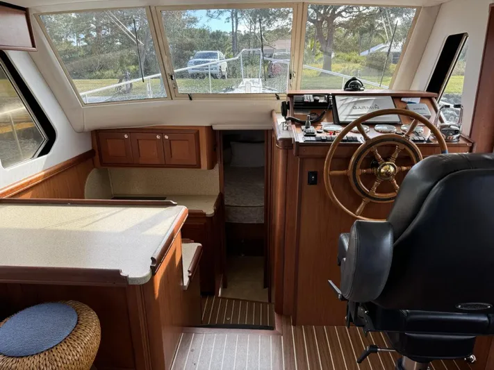 Getaway Yacht Photos Pics 2008 Mainship 34 Trawler Hardtop interior with helm, seating, and wood finish.