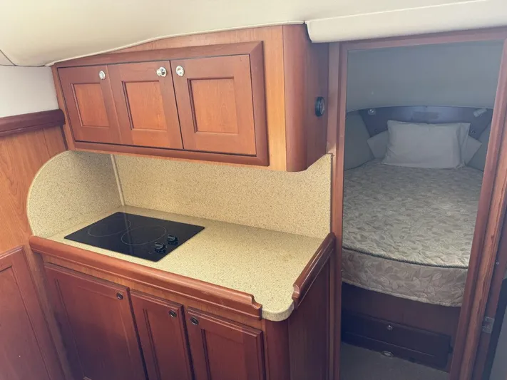 Getaway Yacht Photos Pics 2008 Mainship 34 Trawler Hardtop interior with kitchenette and cozy sleeping area.