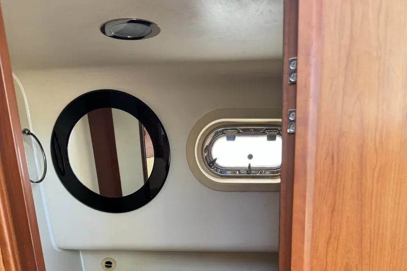 Getaway Yacht Photos Pics 2008 Mainship 34 Trawler Hardtop interior with round mirror and porthole window.