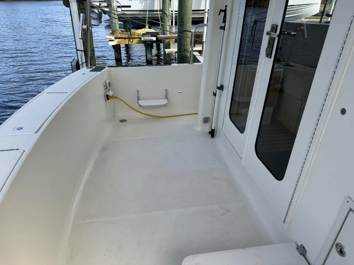 Getaway Yacht Photos Pics 2008 Mainship 34 Trawler Hardtop deck with water view and docked boats.