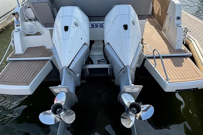  Yacht Photos Pics 2023 Beneteau Antares 11 with dual outboard engines, docked at a marina.