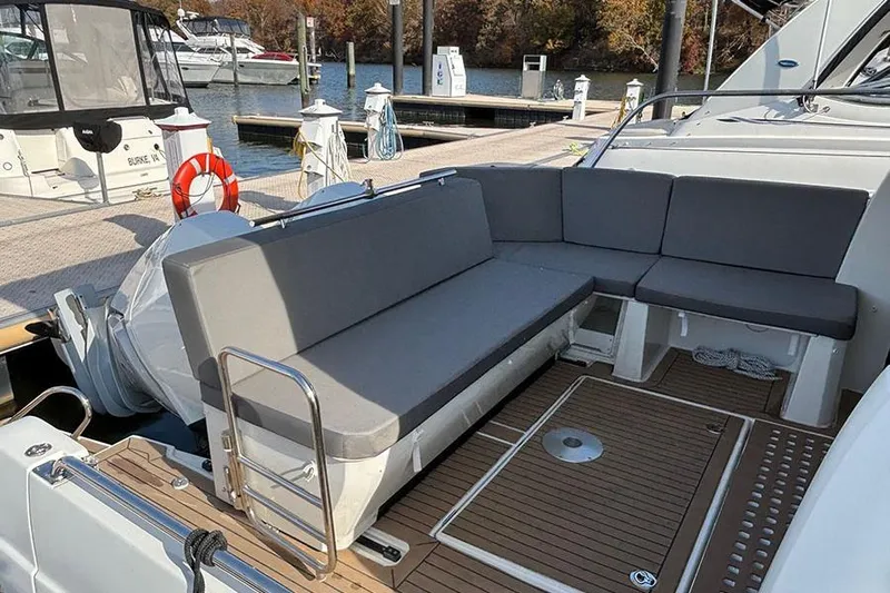  Yacht Photos Pics 2023 Beneteau Antares 11 boat with spacious seating area at the dock.