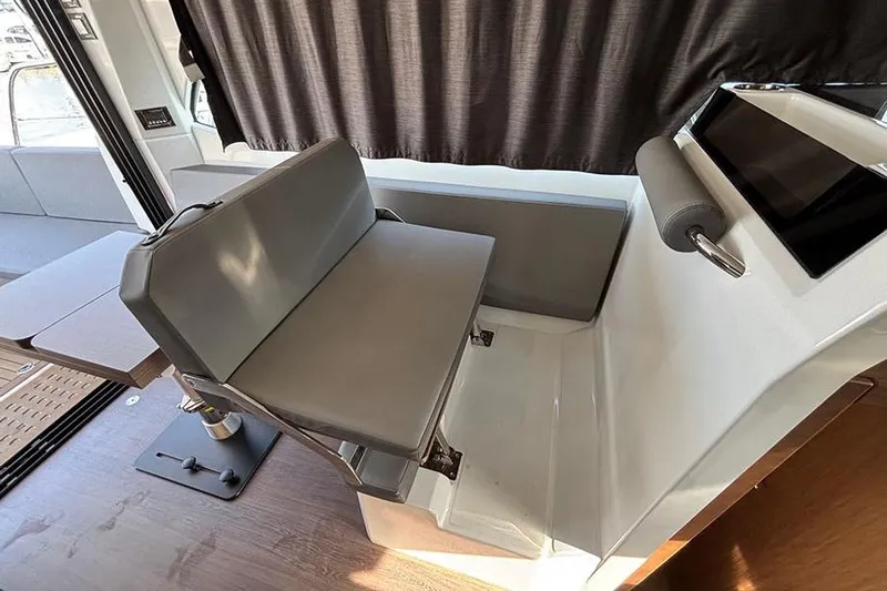 Yacht Photos Pics 2023 Beneteau Antares 11 interior with modern seating and sleek design.