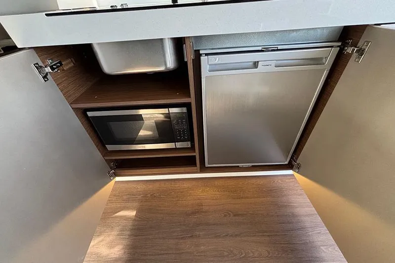  Yacht Photos Pics 2023 Beneteau Antares 11 kitchen with microwave and compact fridge.