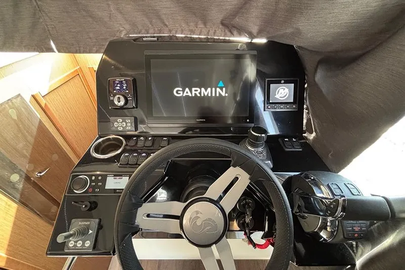  Yacht Photos Pics 2023 Beneteau Antares 11 helm with Garmin navigation system and modern controls.