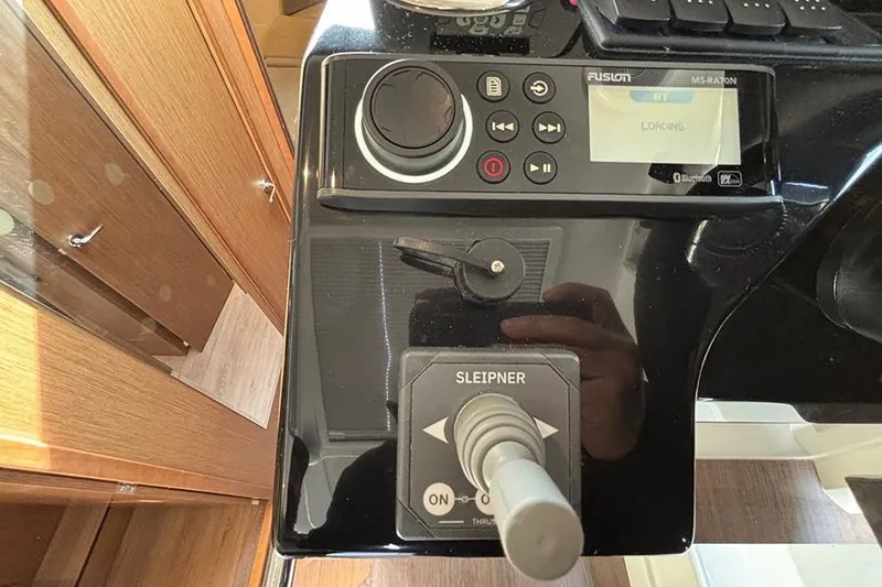  Yacht Photos Pics Control panel of 2023 Beneteau Antares 11 with Fusion audio system and joystick.