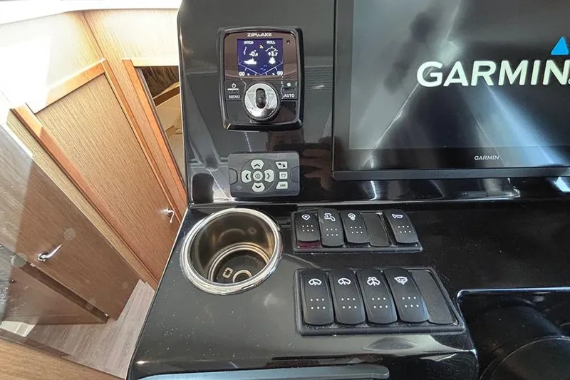  Yacht Photos Pics Control panel of 2023 Beneteau Antares 11 with Garmin display and switches.
