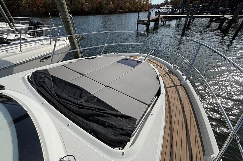  Yacht Photos Pics 2023 Beneteau Antares 11 boat deck with sunbathing area on calm water.