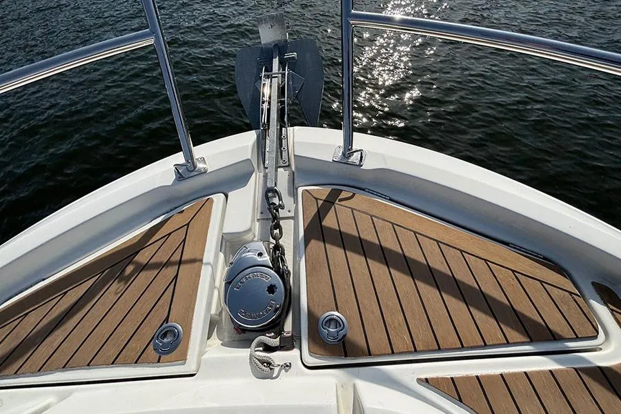 Bow of 2023 Beneteau Antares 11 with anchor and teak decking.