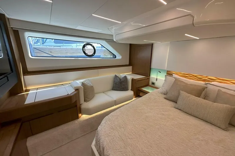 Just Fine Yacht Photos Pics Luxurious interior of 2025 Tiara Yachts EX 60, featuring elegant bedroom and seating area.