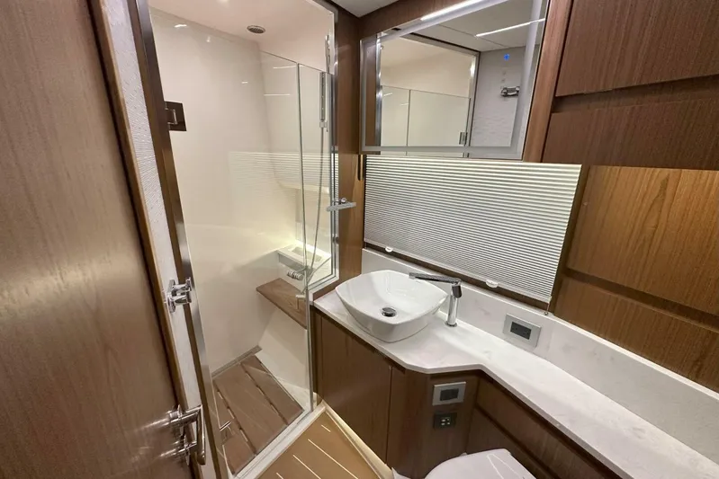 Just Fine Yacht Photos Pics Luxurious bathroom in 2025 Tiara Yachts EX 60, featuring modern fixtures and elegant wood finishes.