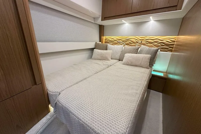 Just Fine Yacht Photos Pics Luxurious 2025 Tiara Yachts EX 60 cabin with elegant bedding and ambient lighting.