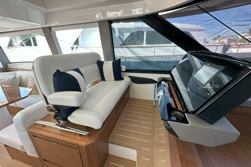 Just Fine Yacht Photos Pics Luxurious interior of 2025 Tiara Yachts EX 60 with plush seating and modern helm.