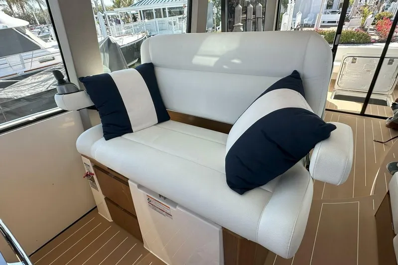 Just Fine Yacht Photos Pics Luxurious seating area on 2025 Tiara Yachts EX 60 with striped cushions.