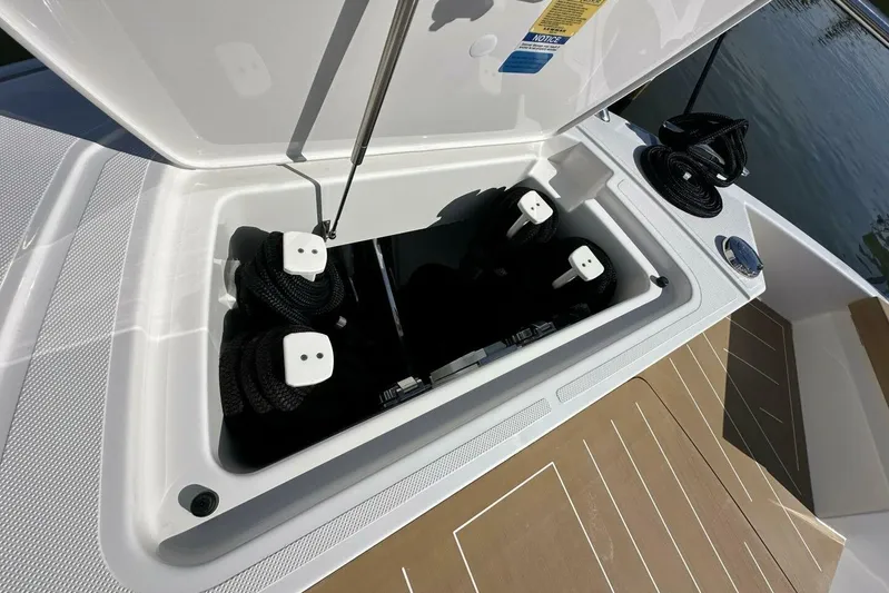Just Fine Yacht Photos Pics Storage compartment on 2025 Tiara Yachts EX 60, featuring neatly coiled ropes.