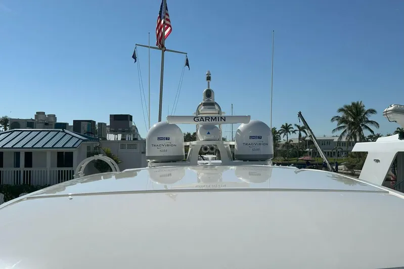 Just Fine Yacht Photos Pics 2025 Tiara Yachts EX 60 with Garmin and TracVision equipment, docked under clear blue sky.