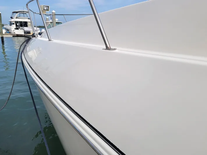 True Blue Yacht Photos Pics 2003 Cruisers Yachts 3772 Express docked at marina, side view.