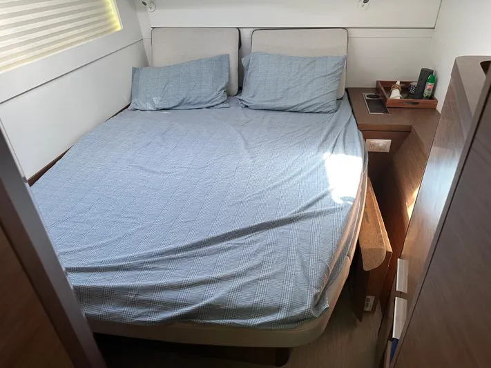  Yacht Photos Pics Cozy bedroom in a 2020 Lagoon 40 yacht with a neatly made bed.