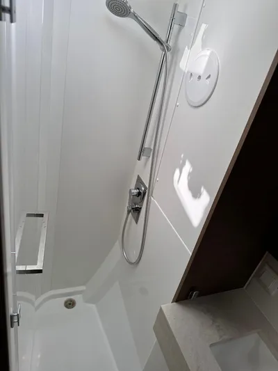  Yacht Photos Pics Modern shower area in a 2020 Lagoon 40 yacht, featuring sleek fixtures and white interior.