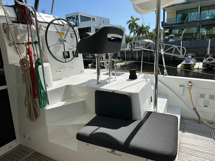  Yacht Photos Pics Helm station of 2020 Lagoon 40 catamaran docked at marina, featuring modern seating and controls.
