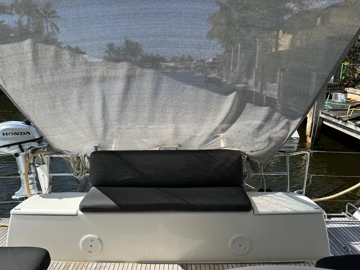  Yacht Photos Pics 2020 Lagoon 40 yacht with shaded seating area and Honda outboard motor.