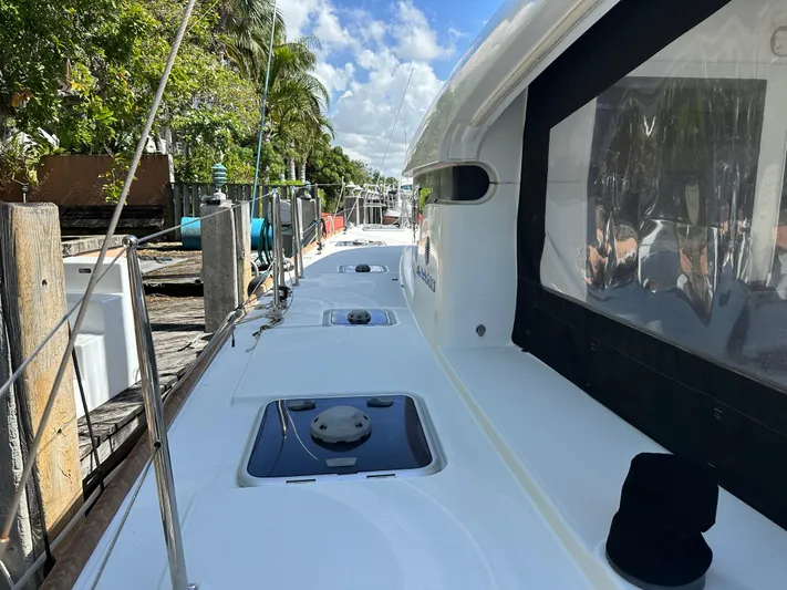  Yacht Photos Pics 2020 Lagoon 40 catamaran docked, showcasing sleek deck design and lush surroundings.