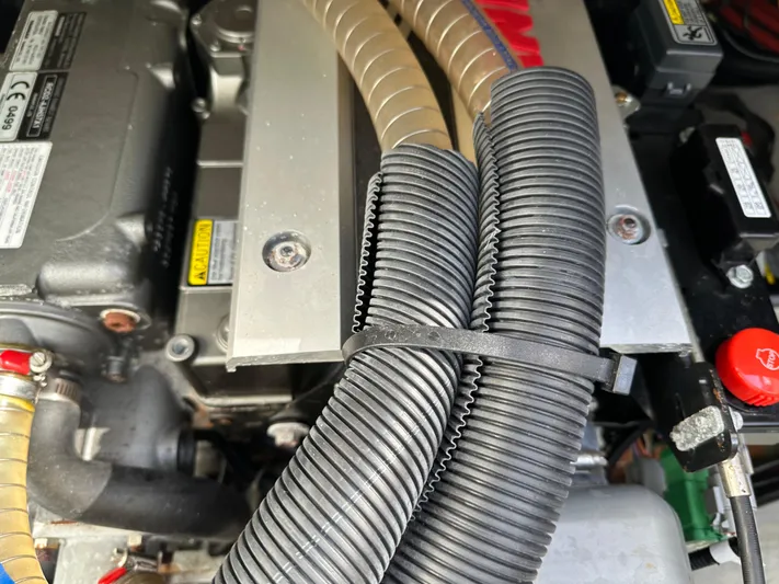  Yacht Photos Pics Engine compartment of a 2020 Lagoon 40, featuring hoses and mechanical components.
