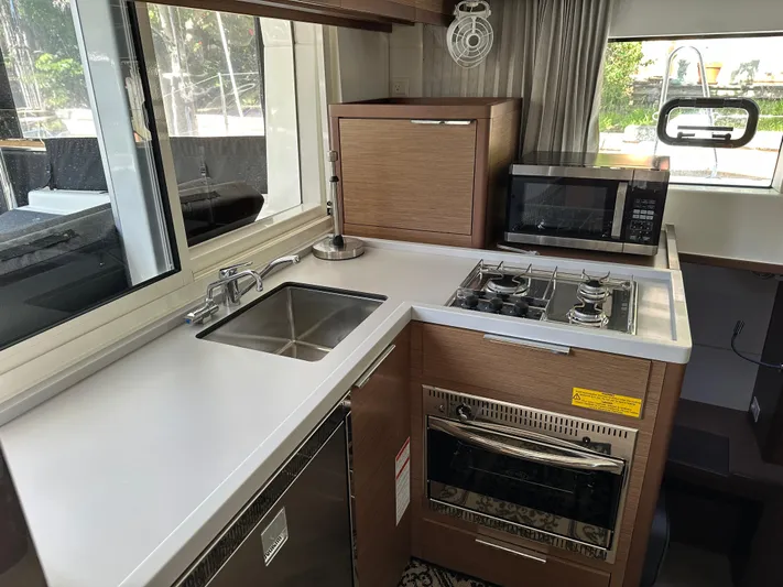  Yacht Photos Pics Modern kitchen in 2020 Lagoon 40 yacht with stove, sink, and microwave.
