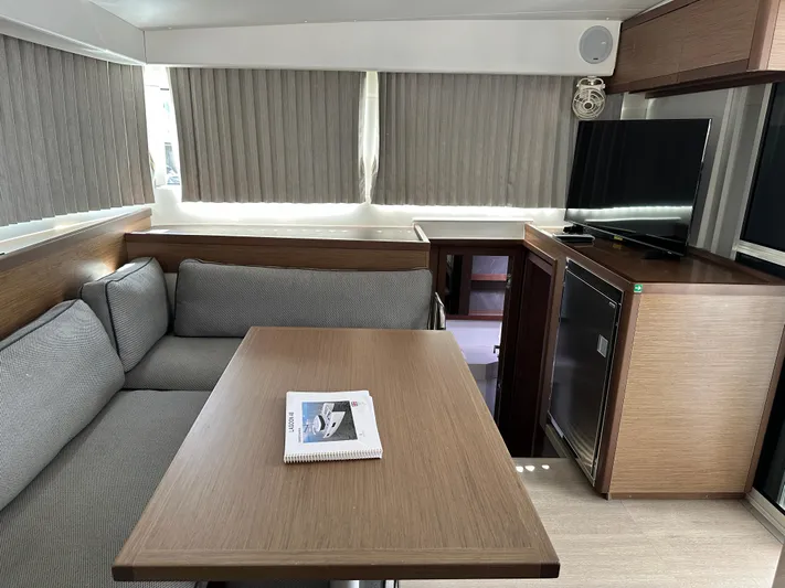  Yacht Photos Pics Modern interior of 2020 Lagoon 40 catamaran with cozy seating and wooden table.
