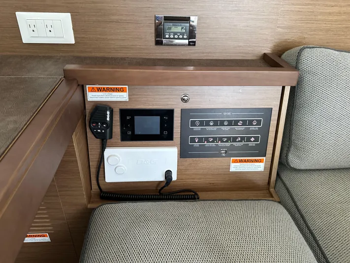  Yacht Photos Pics Control panel in a 2020 Lagoon 40 yacht interior with warning labels and outlets.