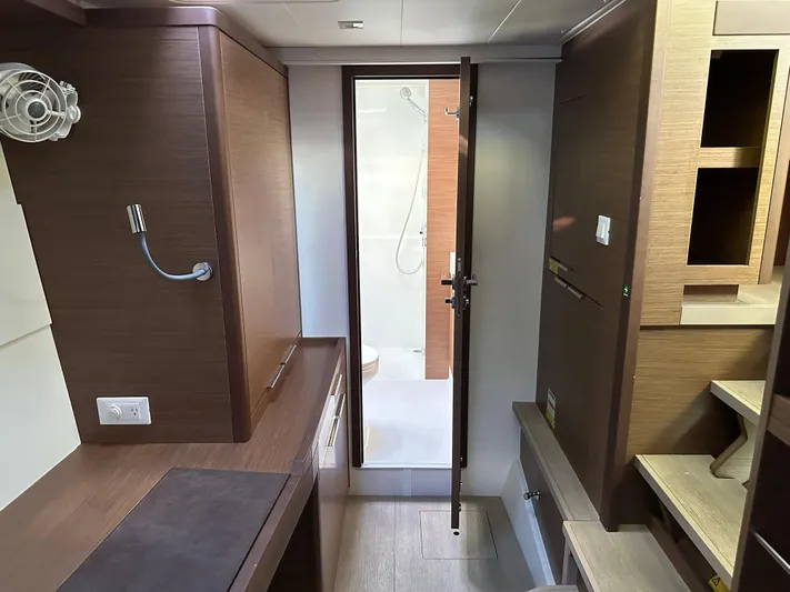  Yacht Photos Pics Interior of 2020 Lagoon 40 yacht, featuring modern wood cabinetry and compact bathroom.