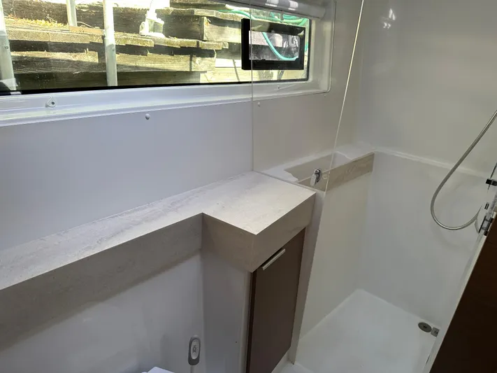  Yacht Photos Pics Modern bathroom interior of 2020 Lagoon 40 catamaran with shower and window.
