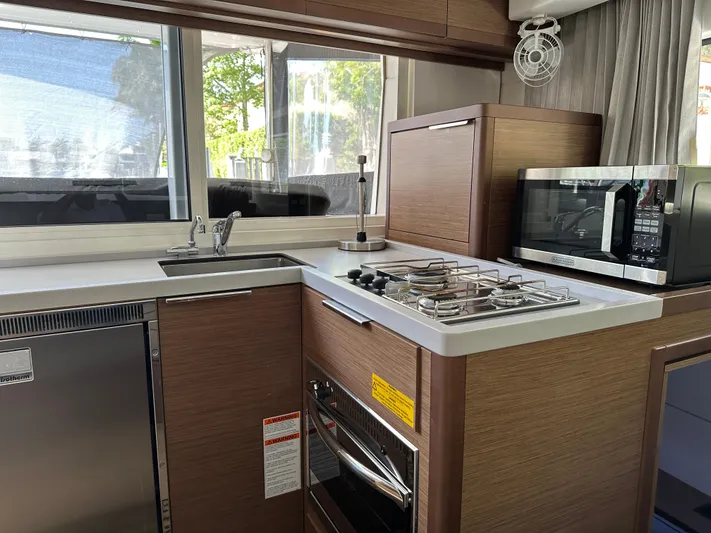  Yacht Photos Pics Modern kitchen in 2020 Lagoon 40 yacht with stove, microwave, and sink.