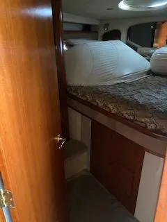 True Blue Yacht Photos Pics 2003 Cruisers Yachts 3772 Express cabin interior with bed and wooden door.