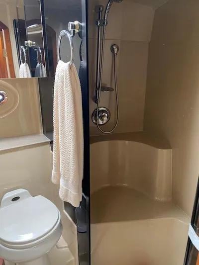 True Blue Yacht Photos Pics 2003 Cruisers Yachts 3772 Express bathroom with shower, toilet, and towel.