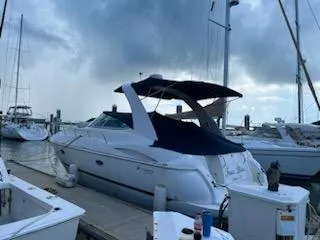 True Blue Yacht Photos Pics 2003 Cruisers Yachts 3772 Express docked at a marina under a cloudy sky.