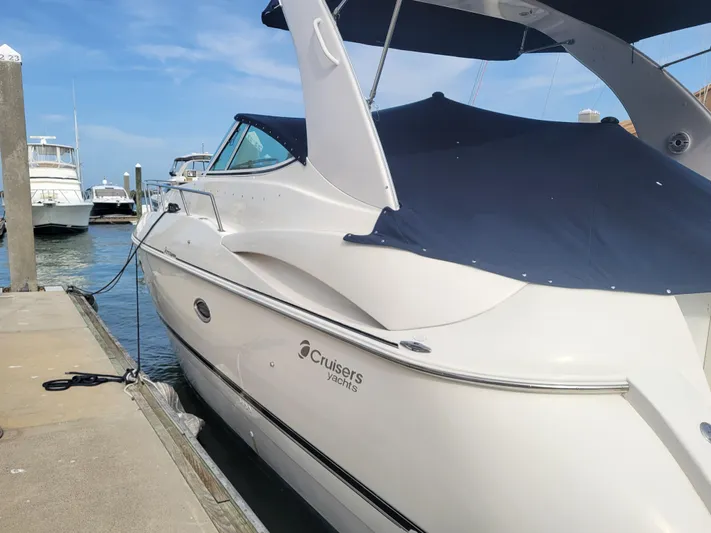 True Blue Yacht Photos Pics 2003 Cruisers Yachts 3772 Express docked at marina, side view.