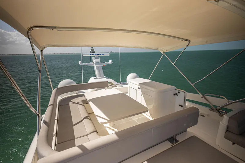 Navegante Yacht Photos Pics Luxurious 2013 Ferretti Yachts 690 flybridge with seating, table, and ocean view.