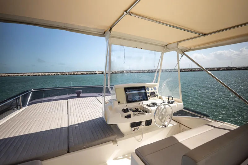 Navegante Yacht Photos Pics Flybridge of 2013 Ferretti Yachts 690 with helm station, overlooking serene ocean view.