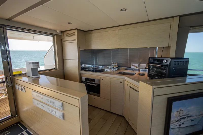Navegante Yacht Photos Pics Luxurious kitchen interior of 2013 Ferretti Yachts 690 with modern appliances and ocean view.