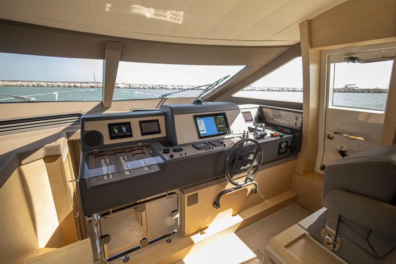 Navegante Yacht Photos Pics Luxurious helm of 2013 Ferretti Yachts 690 with modern navigation equipment.