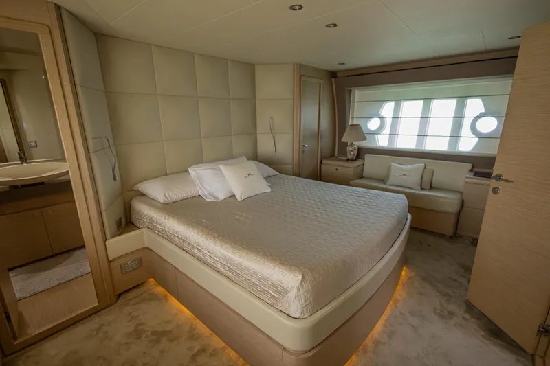 Navegante Yacht Photos Pics Luxurious bedroom interior of 2013 Ferretti Yachts 690 with elegant furnishings and ambient lighting.