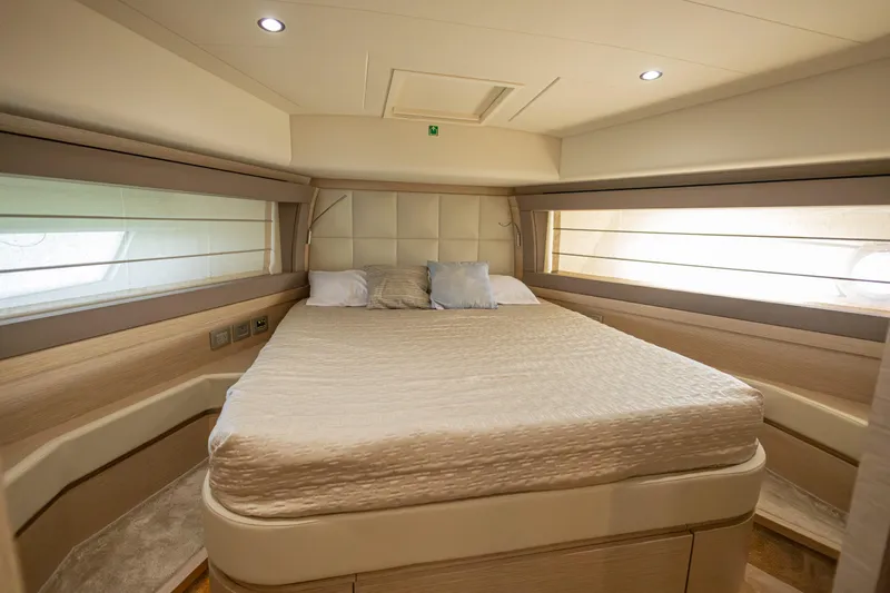 Navegante Yacht Photos Pics Luxurious bedroom interior of 2013 Ferretti Yachts 690 with elegant bedding and ambient lighting.