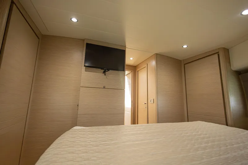 Navegante Yacht Photos Pics Luxurious interior of 2013 Ferretti Yachts 690 with modern wood paneling and TV.