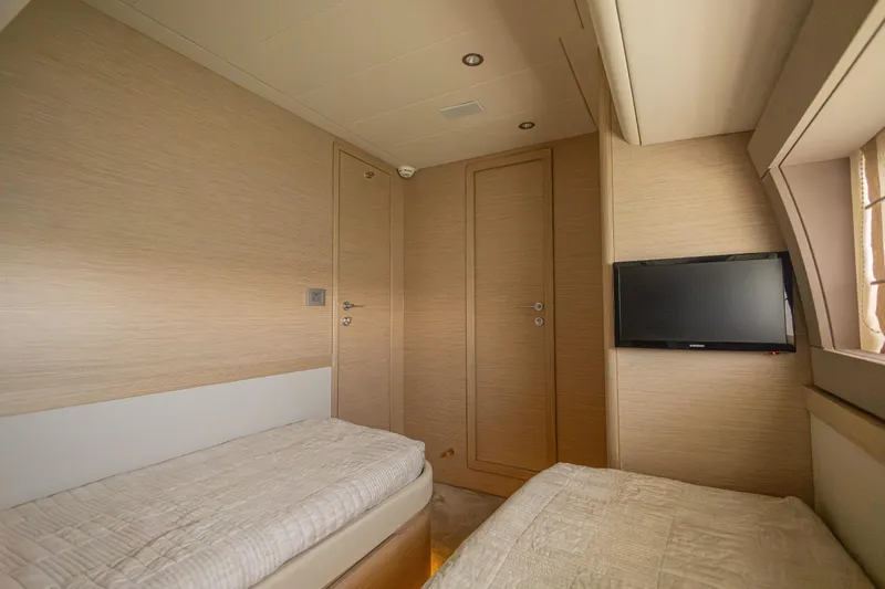 Navegante Yacht Photos Pics Luxurious cabin interior of 2013 Ferretti Yachts 690 with twin beds and TV.