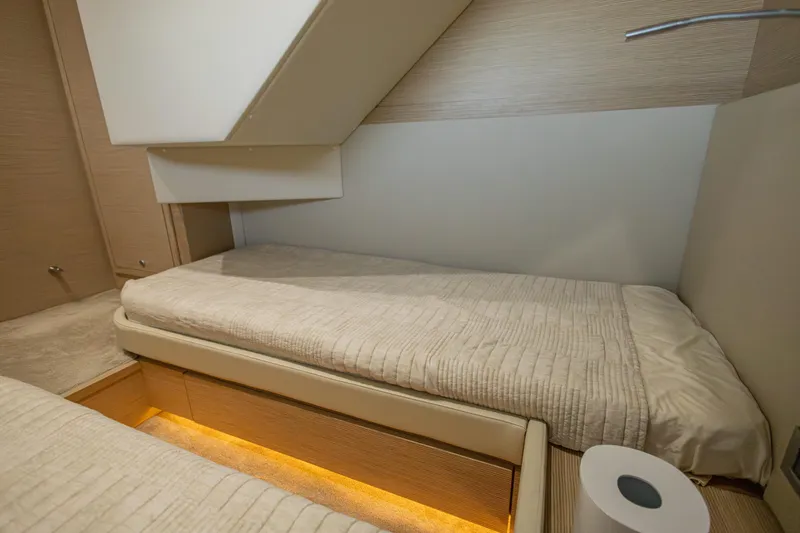 Navegante Yacht Photos Pics Luxurious cabin interior of 2013 Ferretti Yachts 690 with cozy bedding and ambient lighting.